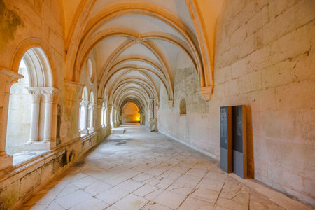 Alcobaca, Portugal - August 15, 2017: Cistercian architecture of corridor with colonnade surrounding the cloister of silence of medieval Roman Catholic Monastery of Alcobaca.のeditorial素材