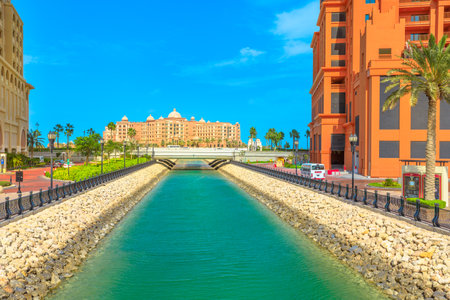 Doha, Qatar - February 18, 2019: blue sea canal of Porto Arabia marina, Pearl-Qatar, Doha, view from lagoon. Marsa Malaz Kempinski luxury hotel on background.Persian Gulf, Middle East.のeditorial素材