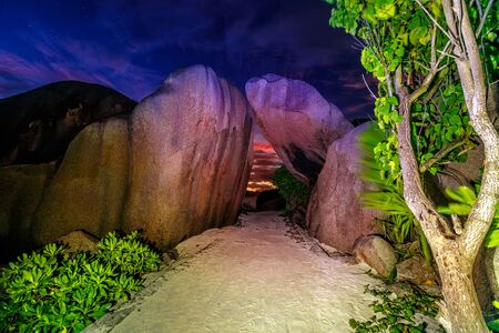 Amazing landscape of huge granite boulders stones at the entrance to Anse Source dArgent Beach at night, Seychelles, La Digue Island.の写真素材