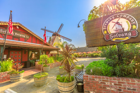 Solvang, California, United States - August 10, 2018: Solvang Brewing Company in Solvang Historic Downtown, a Danish Village in Santa Ynez Valley. Sunny day, blue sky. Old windmill on background.のeditorial素材