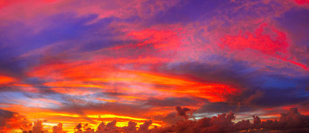 Dramatic banner panorama of cloudscape in twilight with sunset. Soft, fluffy and colorful cloud...