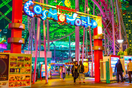 Yokohama, Japan - April 21, 2017: people at entrance and signboard of Cosmo World amusement park in Minato Mirai 21 district of Yokohama with Cosmo Clock 21, a giant Ferris wheel.のeditorial素材