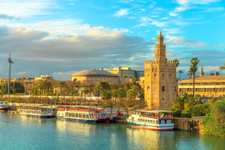 Seville, Andalusia, Spain - April 19, 2016: Golden tower or Torre del Oro, a medieval military control tower on riverside of Seville at sunset. City sightseeing from Guadalquivir River Cruise.のeditorial素材