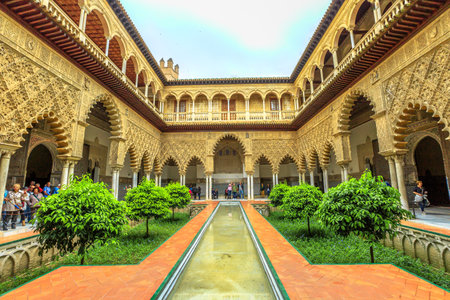 Seville, Andalusia, Spain - April 19, 2016: Patio de las Doncellas in Royal Alcazars of Seville or Reales Alcazares de Sevilla, Andalusian Architecture and old Arab Palace originally fort of Moors.のeditorial素材