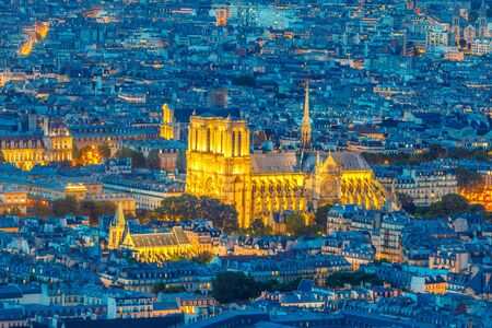 Night view of Notre Dame de Paris from the panoramic terrace of Tour Montparnasse. Closeup of Notre Dame Gothic Church the most important religious monument of the French capital. Paris urban skyline.の写真素材