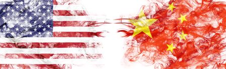 American and Chinese flags in smoke shape on white background. Concept of conflict war and custom duty. America VS China metaphor. Dollar Yuan exchange currency and international commercial crisis.の写真素材