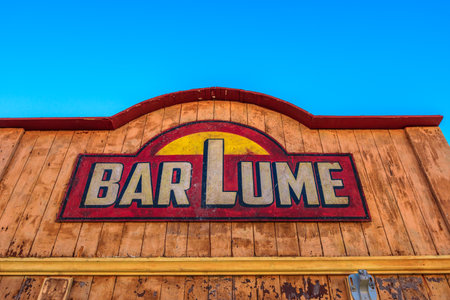 Marciana Marina, Elba island, Italy - June 17, 2020: Closeup of Logo of location set of The crimes of BarLume fiction serie TV taken from a novel bestseller at Marciana Marina. Popular travel landmarkのeditorial素材