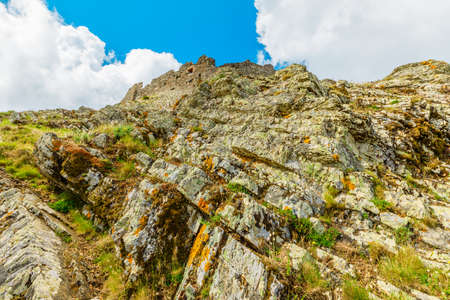 View from back side of Volterraio Castle built 1284 on rock at 394m. Fortress of Volterraio, symbol of Elba Island. Landscape of Elba mountains. Impossible climb of rock fortress in Tuscany, Italy.の写真素材