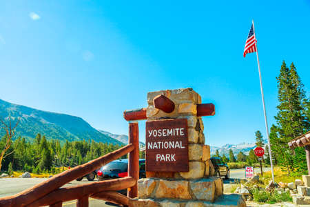 Entrance gate with American flag of Yosemite National Park. Summer American holidays in California of United States of America.の写真素材