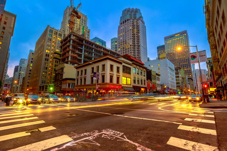 San Francisco, California, United States - August 15, 2019: Crossroad of San Francisco downtown by night. Light trails of cars in city traffic and Californian nightlife.のeditorial素材
