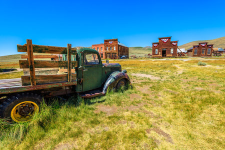Rusty wreck of a vintage old truck if wood. Bodie state historic park, Californian Ghost Town of the 1800s in the United States of America. Close to Yosemite national park.のeditorial素材