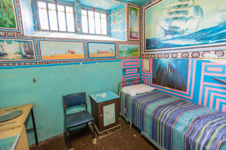 Fremantle, Western Australia - Jan 5, 2018: single cell with bed and painting of Fremantle Prison an old convicts jail built in 1855. Memorial museum and UNESCO World Heritage.のeditorial素材
