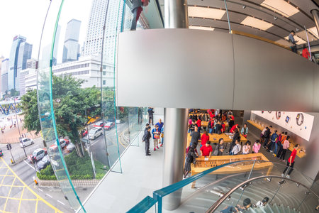 Hong Kong, China - December 4, 2016: fish-eye interior prospective view inside Apple store with glass stairway, IFC Mall, customers looking for best new technological products.のeditorial素材