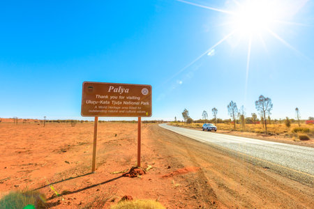 Uluru, Northern Territory, Australia - Aug 25, 2019: tourist car drive to Uluru.Palya Thank you for visiting Uluru-Kata Tjuta National Park-a world heritage area signboard.Austrian outback landscapeのeditorial素材