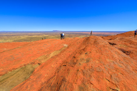 Uluru, Northern Territory, Australia - Aug 23, 2019: people looking Mount Olga rock formation in the distance, at a top of Ayers Rock in Uluru-Kata Tjuta National Park.のeditorial素材