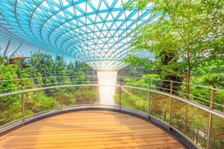 Singapore - Aug 8, 2019: scenic Rain Vortex, the worlds largest indoor waterfall surrounded by a four-story terraced forest in Jewel Changi Airport opened on April 2019.のeditorial素材