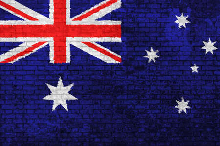 wall of bricks painted with the flag of Australia, red blue white colors. 3d background. Concept of social barriers of immigration, divisions, and political conflicts in Australia.の写真素材