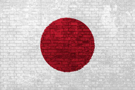 wall of bricks painted with the flag of Japan, red white colors. 3d background. Concept of social barriers of immigration, divisions, and political conflicts in Japan.の写真素材