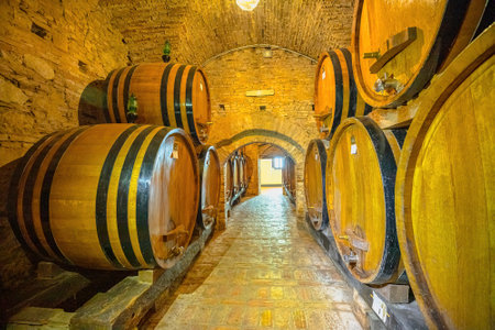 Montepulciano, Tuscany, Italy - October 4, 2021: cellar room with barrels of red wine in wood. Inside the ancient Contucci Winery, family of winemakers since 1700s, from Montepulciano town.のeditorial素材