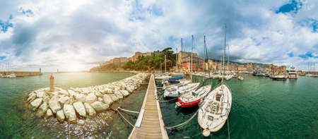 Aerial view on the pier of Bastia city downtown with lighthouse and yachts docked. Drone view of cityscape with the city port in Mediterranean sea in Corsica island of France. 360 degrees panoramaの写真素材