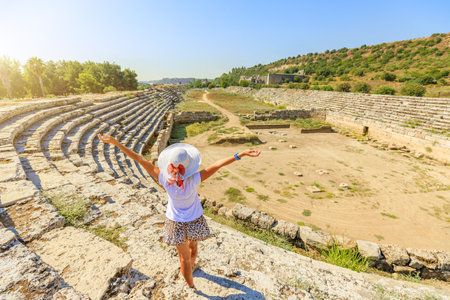 Visitors to Perge town, can explore its grand colonnaded streets, admire intricate mosaics, and stand in awe of its monumental architecture. Aerial view on ancient ruins of Perge city of Turkey.の写真素材