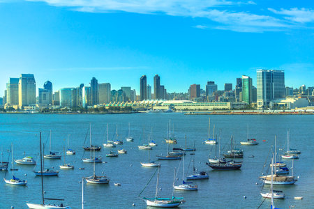 Aerial view of sailboats in San Diego Bay seen from Coronado Bridge with San Diego on urban skyline background. California, United States.の写真素材