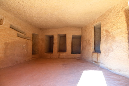 Jabal AlBanat with the interior of a rock-cut tomb in Hegra, Al-Ula, Saudi Arabia, showcasing burial niches and ancient architecture, offering a glimpse into Nabataean history and cultureの写真素材