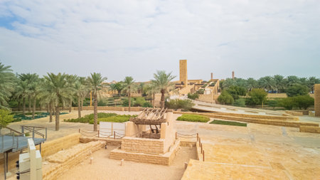 Panoramic view of Diriyah, a historic city near Riyadh, Saudi Arabia, featuring traditional architecture, lush palm groves, and modern structures in a UNESCO World Heritage siteの写真素材