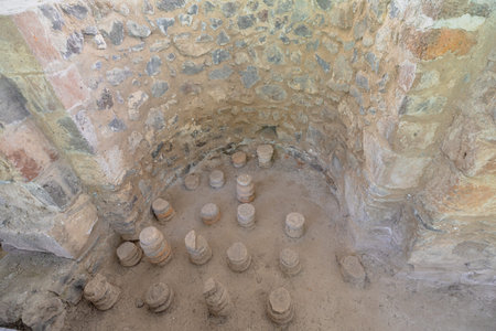 Hypocaust heating system with brick pilae supporting the floor in the roman bath ruins of Garni...