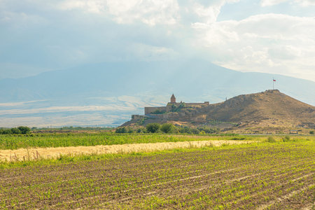 Khor Virap. An ancient Armenian monastery. Stands on a hill overlooking cultivated fields. With...