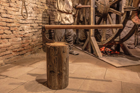 Transylvania, Romania - Oct 8, 2025: Museum exhibit at Corvin Castle, Hunedoara, Romania, displaying medieval torture devices, including an executioner's ax and blockのeditorial素材