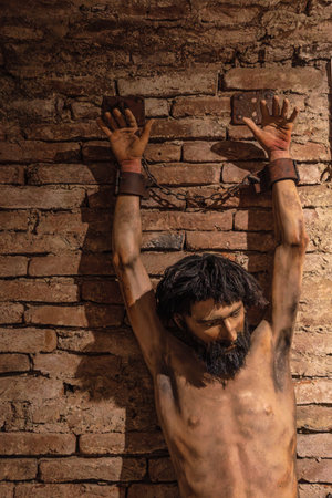 Transylvania, Romania - Oct 8, 2025: Mannequin representing prisoner in ancient torture chamber at Corvin Castle, Hunedoara, Romania, conveying historical suffering and imprisonmentのeditorial素材