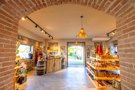 Martinique, French Antilles - Dec 26, 2025: Historic interior of Rhum Agricole Hardy distillery in Martinique, featuring a textured stone wall, brick arch, and modern lightingのeditorial素材