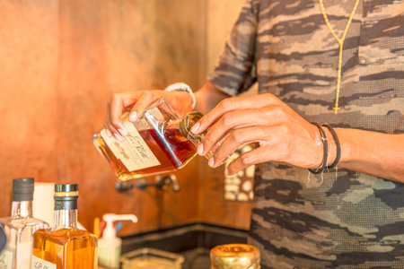 Sainte-Marie, Martinique, French Antilles - Dec 27, 2025: an expert explaining the craft behind Rhum Agricole while offering tastings from La Salle distillery in Martinique.のeditorial素材