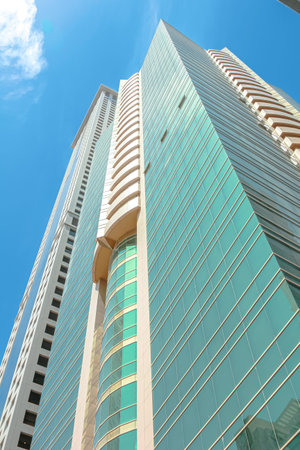 Dubai, United Arab Emirates - May 1, 2013: Dubai skyscraper with glass facade and balconies rising...