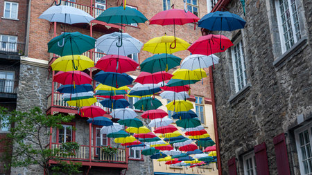 Famous place in the old Quebec City with colored umbrellas above a pedestrian streetの写真素材