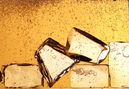 ice cubes jumping in whisky glassの写真素材