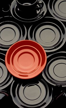  Red and black cups with black coffee saucerの写真素材