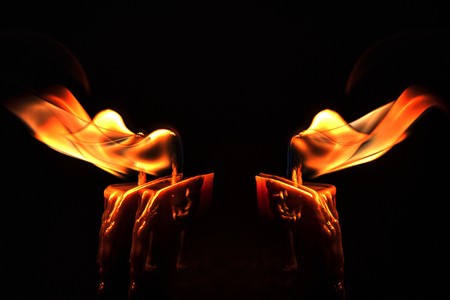 Close-up of a burning candles mixed in a low-key imageの写真素材