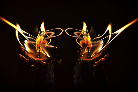 Close-up of a burning candles mixed in a low-key imageの写真素材