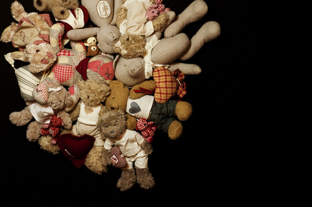 Pile of teddy bears on a black backgroundの写真素材