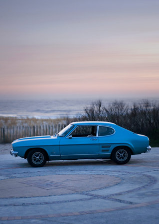 A blue Ford Mustang 2300 GT on the sea front in France, no plates