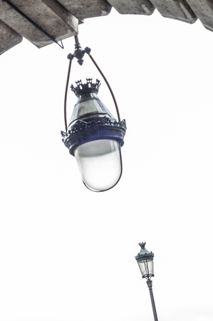 Vintage street lamps under a metro viaduct in Parisの写真素材