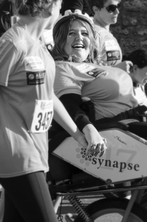 Handicapped woman is smiling at her friend during Les 10iemes FoulÃ©es marathon in Angouleme, France, in April 2016のeditorial素材