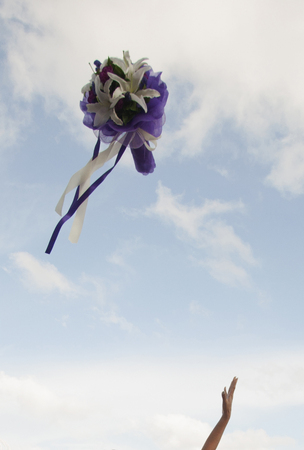 Flower bouquet thrown in the air by the bride during a traditional Thai weddingの写真素材