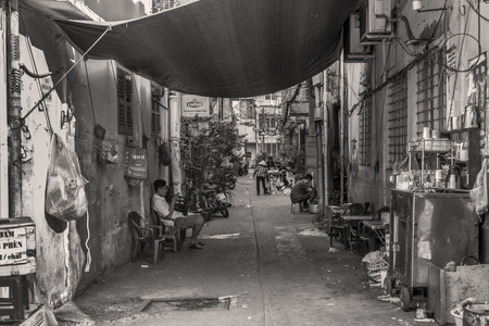 People are going on with their lives in a small alley of Ho Chi Minh City, Vietnam.のeditorial素材