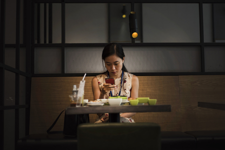 Vietnamese woman is browsing on her mobile in Ho Chi Minh City, Vietnam,のeditorial素材