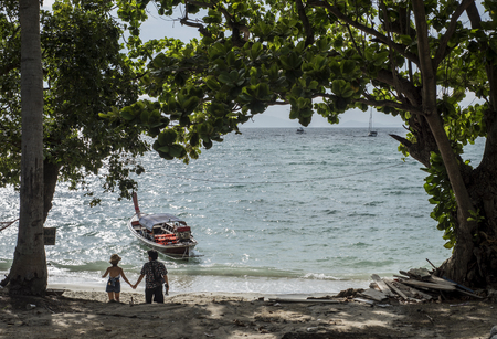Chinese couple goes down to the beach on Koh Lipe, Thailand.の写真素材