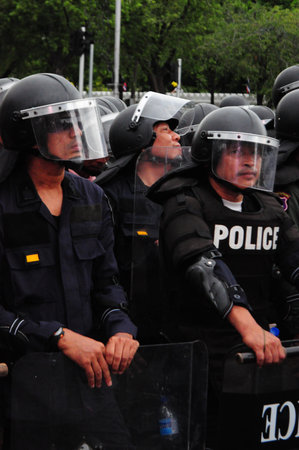 Bangkok/Thailand - 11 24 2012: Riot police face protesters at Royal Plaza.