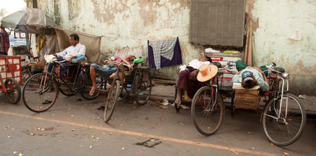Rickshaw riders nap in the street